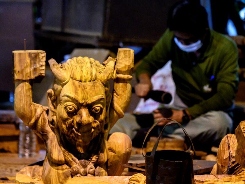 This photograph taken on September 2, 2020 shows workers carving elements for the all wooden Sanctuary of Truth Hindu-Buddhist temple and museum in Pattaya. Mladen ANTONOV / AFP