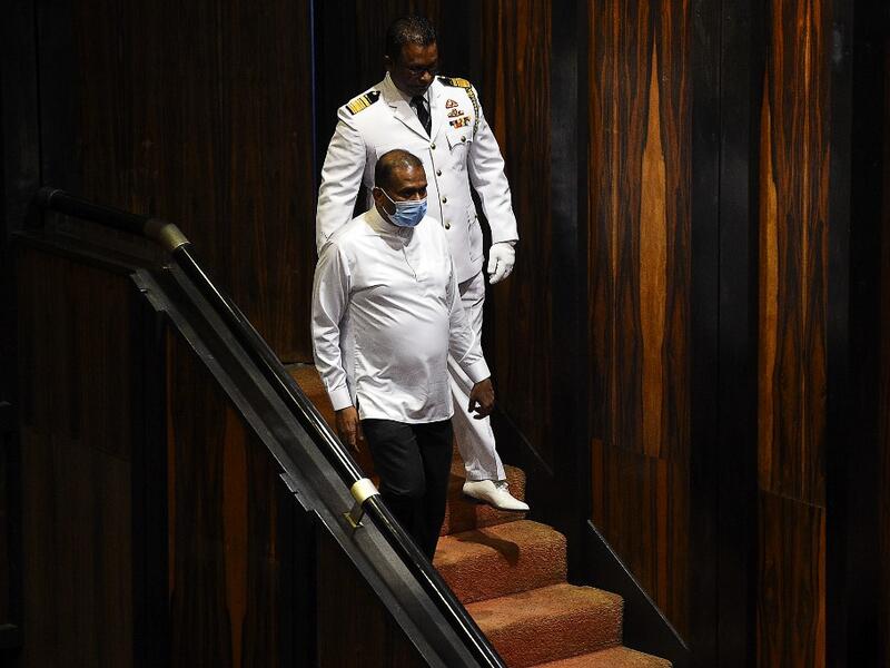 Sri Lanka's convicted murderer Premalal Jayasekara (L) arrives for a sworn in as a member of parliament from the ruling party in Colombo on September 8, 2020. Jayasekara becomes the first convict facing a death sentence to become a legislator in Sri Lanka. ISHARA S. KODIKARA / AFP