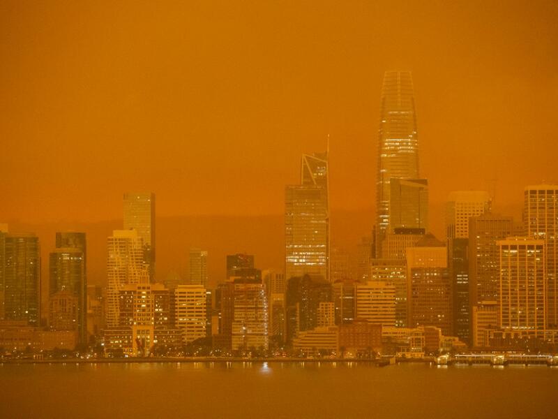 The San Francisco skyline is obscured in orange smoke and haze as their seen from Treasure Island in San Francisco, California on September 9, 2020. More than 300,000 acres are burning across the northwestern state including 35 major wildfires, with at least five towns "substantially destroyed" and mass evacuations taking place. Brittany Hosea-Small / AFP