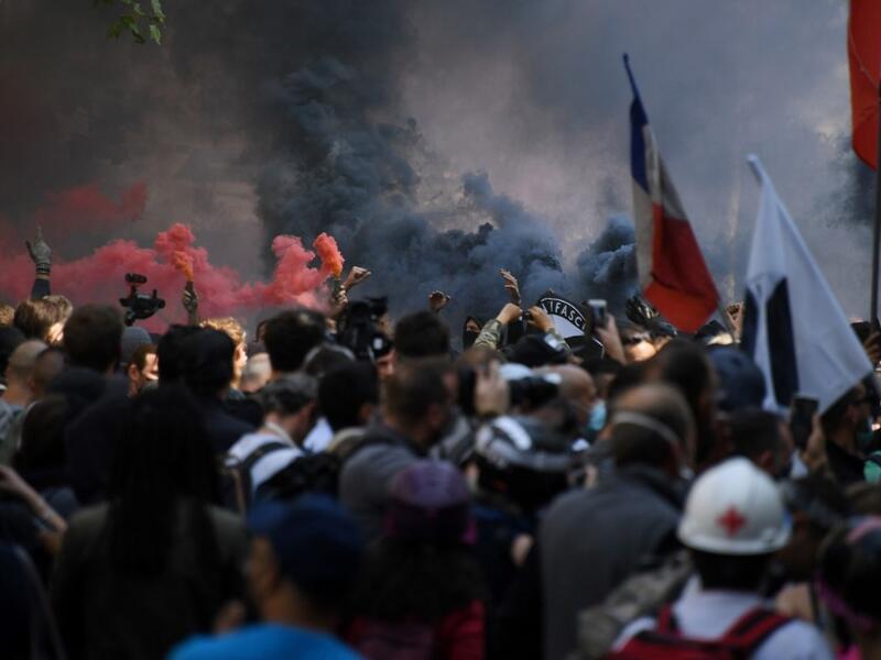 Protesters light flares during a demonstration called by the "yellow vest" (gilets jaunes) movement on September 12, 2020 in Paris. Alain JOCARD / AFP