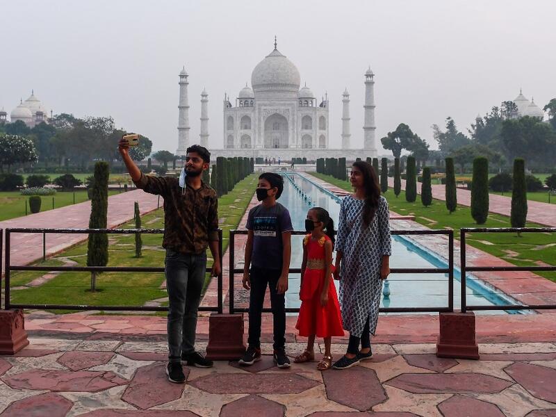 Tourists visit the Taj Mahal in Agra on September 21, 2020. The Taj Mahal reopened to visitors on September 21 in a symbolic business-as-usual gesture even as India looks set to overtake the US as the global leader in coronavirus infections. Sajjad HUSSAIN / AFP