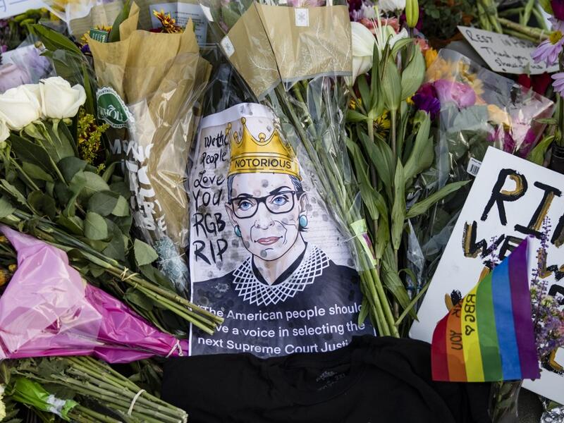 Mourners place flowers, messages, and mementos at a makeshift memorial in honor of Supreme Court Justice Ruth Bader Ginsburg in front of the US Supreme Court on September 19, 2020 in Washington, DC. Justice Ginsburg has died at age 87 after a battle with pancreatic cancer. Samuel Corum/Getty Images/AFP Samuel Corum / GETTY IMAGES NORTH AMERICA / Getty Images via AFP