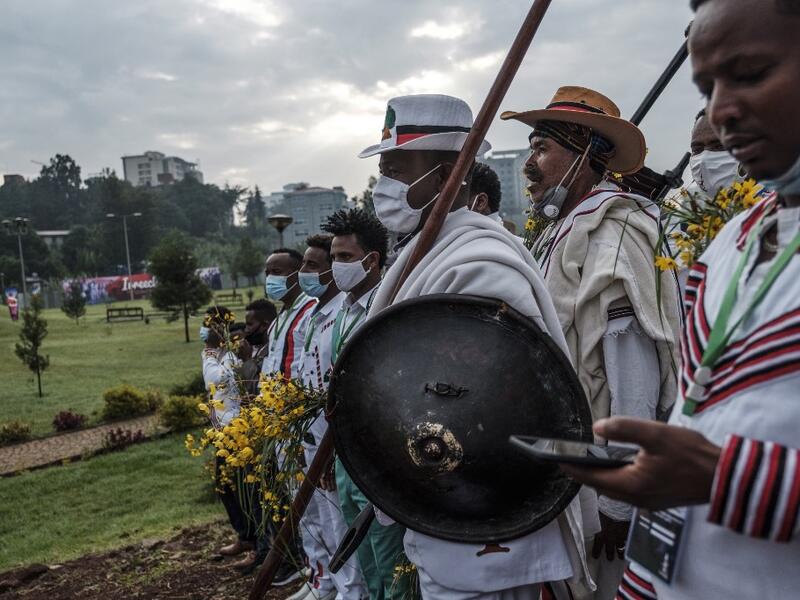 People in traditional clothing march during the celebration of “Irreechaa”, the Oromo people thanksgiving holiday, in Addis Ababa, Ethiopia, on October 3, 2020. Members of Ethiopia's largest ethnic group gathered under heavy security in Addis Ababa for a scaled-back version of their annual thanksgiving festival against a backdrop of unrest and political division. EDUARDO SOTERAS / AFP