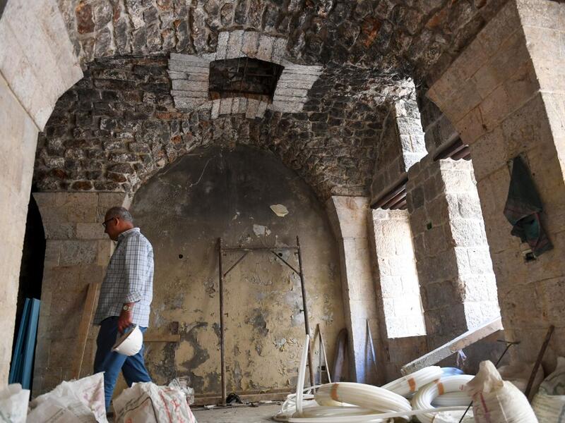 Syrian workers take part in the reconstruction of Martini restaurant and hotel in the Jdaideh neighbourhood in Aleppo's Old City on October 17, 2020. AFP
