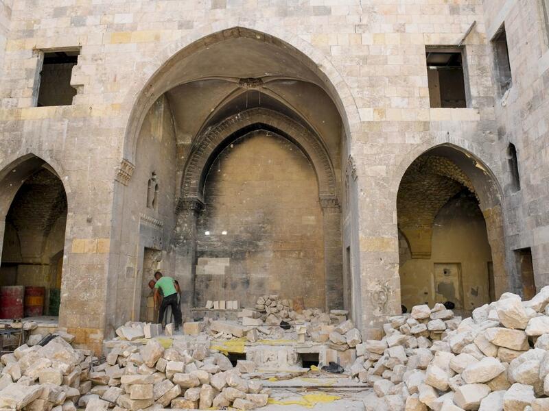 Syrian workers take part in the reconstruction of Martini restaurant and hotel in the Jdaideh neighbourhood in Aleppo's Old City on October 17, 2020. AFP