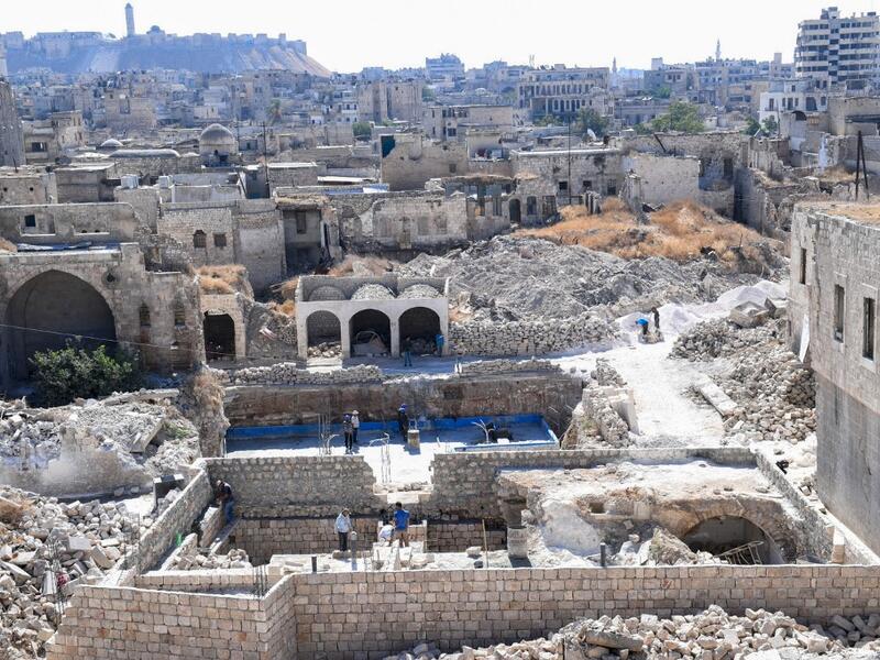 Syrian workers take part in the reconstruction of Martini restaurant and hotel in the Jdaideh neighbourhood in Aleppo's Old City on October 17, 2020. AFP
