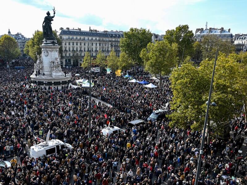 People gather on Place de la Republique in Paris on October 18, 2020, in homage to history teacher Samuel Paty two days after he was beheaded by an attacker who was shot dead by policemen. BERTRAND GUAY / AFP