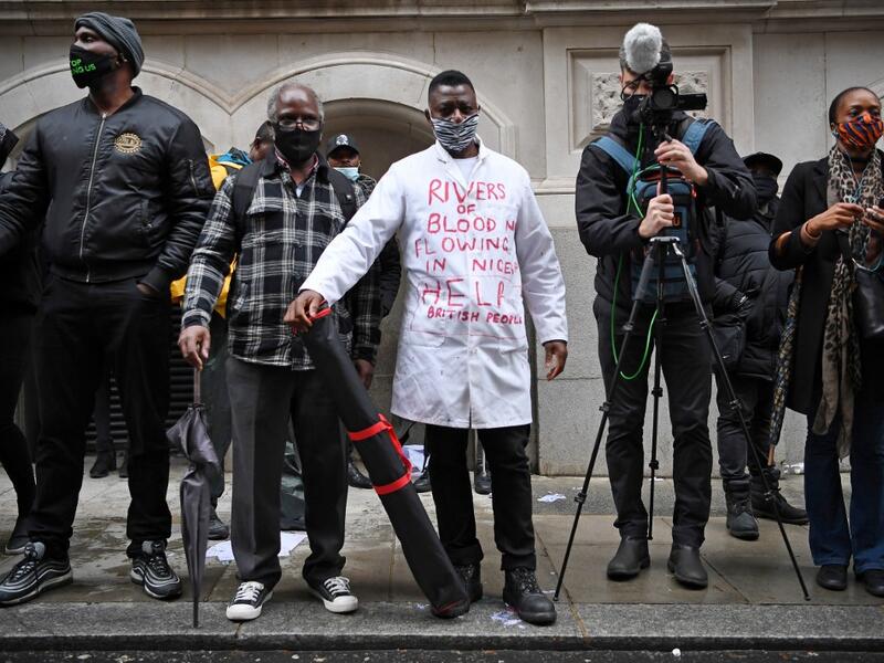 Protestors attend a demonstration outside the Nigerian High Commission against police brutality in Lagos in London on October 21, 2020. UN Secretary General Antonio Guterres called Wednesday for an end to what he called "brutality" by police in Nigeria, which has been rocked by two weeks of protests. Guterres said gunmen that opened fire on peaceful protesters Tuesday evening in Lagos caused "multiple deaths" and many injuries. Daniel LEAL-OLIVAS / AFP