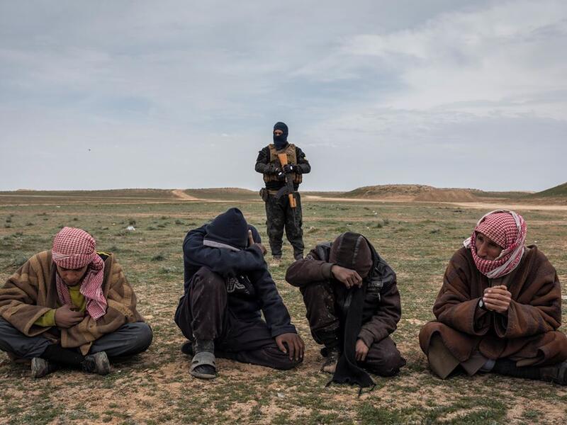 Men who have fled a final area of IS control wait to be questioned near Baghuz, Syria, about their links to the group, on 7 February 2019.⁣ ⁣ From ‘ISIS and its Aftermath in Syria’ by Ivor Prickett (@ivorprickett) for The New York Times (@nytimes).⁣
