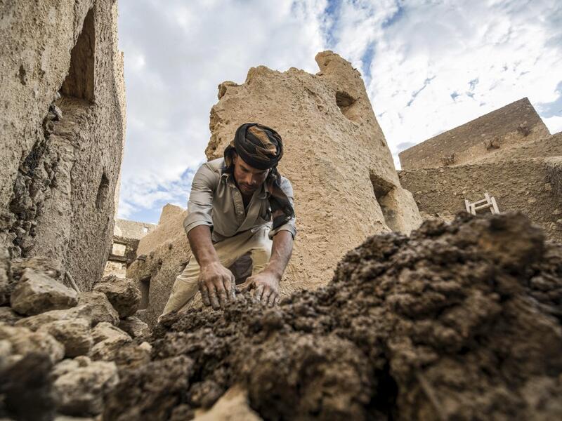 An Egyptian labouror works on the restoration of the fortress of Shali, in the Egyptian desert oasis of Siwa, some 600 kms southwest of the capital Cairo, on November 5, 2020. The 13th century edifice, called Shali or "Home" in the Siwi language, was built by Berber populations, using kershef, a mixture of clay, salt and rock which acts as a natural insulator in an area where the summer heat can be scorching. Khaled DESOUKI / AFP