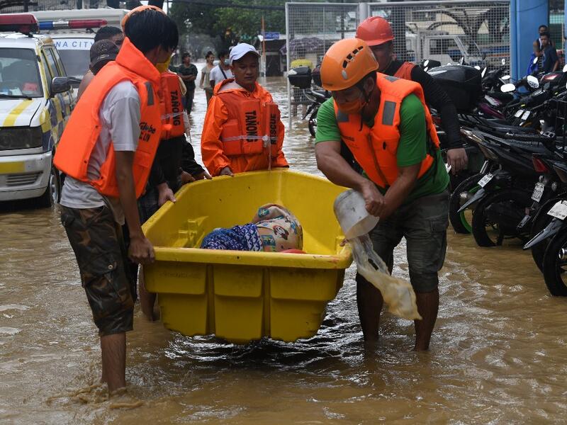 Rescuers evacuate an elderly resident from her flooded home after Typhoon Vamco hit, in Marikina City, suburban Manila on November 12, 2020. Ted ALJIBE / AFP