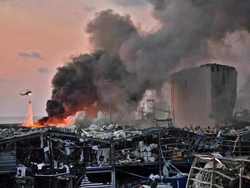 A helicopter puts out a fire at the scene of an explosion at the port of Lebanon's capital Beirut, Aug. 4, 2020. AFP