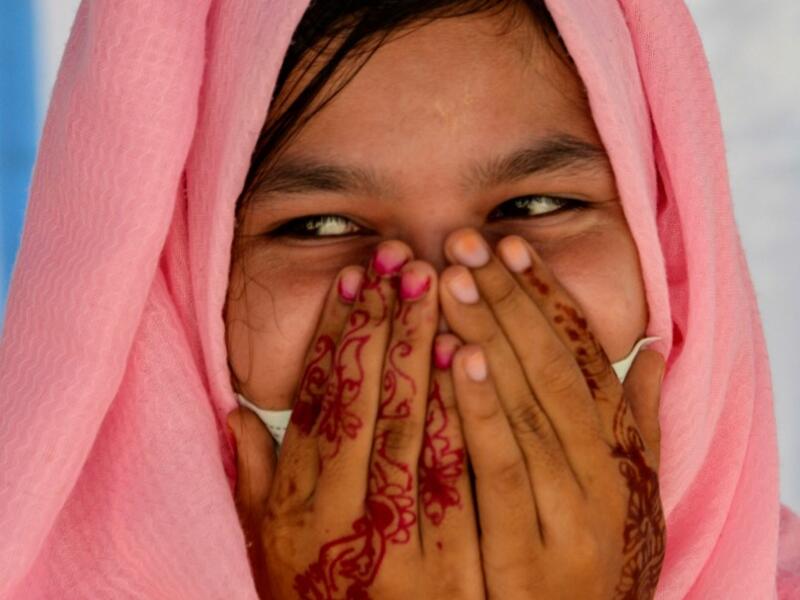 This photo taken on October 21, 2020 shows Rohingya refugee Amerah, 18, who said she has not seen her fiance -- who is a construction worker in Malaysia -- since she was six, at a temporary shelter in Lhokseumawe in Aceh province. Stay in a squalid refugee camp -- hopeless, starving, and made to feel a burden -- or leave, risking death, rape, human trafficking and months at sea to reach a husband you've never met. This is the bleak choice many Rohingya women, already scarred from fleeing persecution in Myan
