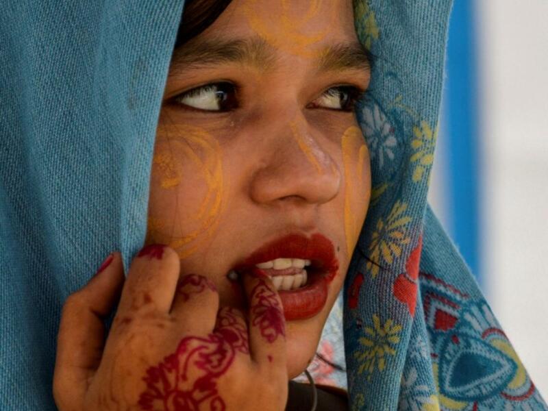 This photo taken on October 22, 2020 shows Rohingya refugee Amerah, 18, who said she has not seen her fiance -- who is a construction worker in Malaysia -- since she was six, at a temporary shelter in Lhokseumawe in Aceh province. Stay in a squalid refugee camp -- hopeless, starving, and made to feel a burden -- or leave, risking death, rape, human trafficking and months at sea to reach a husband you've never met. This is the bleak choice many Rohingya women, already scarred from fleeing persecution in Myan