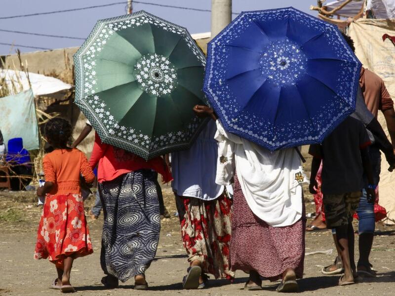 Ethiopian refugees, who fled the fighting in Tigray Region, are pictured walking at a border reception centre (Village 8) in Gedaref State, eastern Sudan, on November 29, 2020. ASHRAF SHAZLY / AFP
