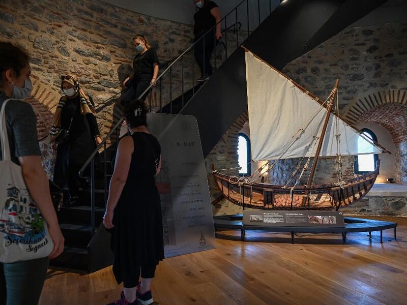 Archaelogical artfacts founds in Istanbul are on display as people visit after the restoration of the Galata Tower on October 16, 2020 in Istanbul. The Galata Tower -- an emblematic 14th century monument of Istanbul -- has become the latest victim of such controversy. Ozan KOSE / AFP