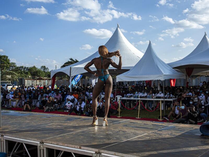 A bodybuilder poses on stage during the Iron Fit Bodybuilding competition in Nairobi on December 05, 2020. 130 participants from all across East Africa took part in the second edition of this competition which included categories like Bikini, Figure, Physique and Bodybuilding. Patrick Meinhardt / AFP