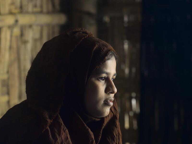 In this photograph taken on October 13, 2020, Rohingya refugee Umme Khair, who gave money to a community leader to travel to Malaysia to her husband, sits at a makeshift shelter in Kutupalong Rohingya refugee in Ukhia. Stay in a squalid refugee camp -- hopeless, starving, and made to feel a burden -- or leave, risking death, rape, human trafficking and months at sea to reach a husband you've never met. This is the bleak choice many Rohingya women, already scarred from fleeing persecution in Myanmar, are now