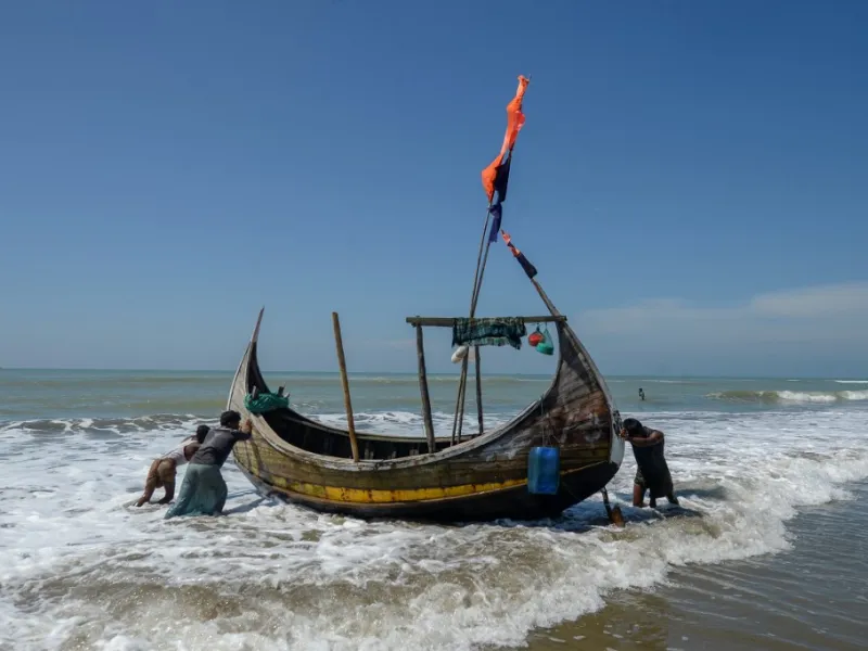 In this photograph taken on October 10, 2020, fishermen set out on a fishing boat at Sabrang beach area, a boarding point of Rohingya refugees migrating to Malaysia by boat. Boatloads of Rohingya landing across Southeast Asia are victims of complex human trafficking networks run by a dizzying web of players, from crime bosses and corrupt cops to poor fishermen, rickshaw drivers and even Rohingya themselves. Munir UZ ZAMAN / AFP