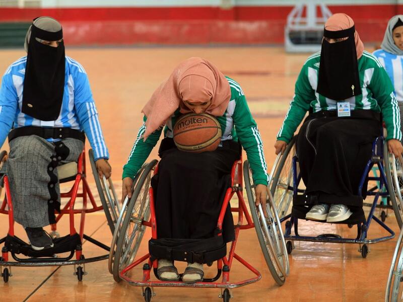 Disabled Yemeni women take part in a local wheelchair basketball championship in Yemen's capital Sanaa on December 8, 2020. In conflict-ridden Yemen, nine teams, including five-all women groups, competed in a local championship for the disabled in the capital Sanaa, which has been under rebel control since 2014. The players are competing to be embraced by society for their strengths rather than be viewed as a burden during the time of war. Mohammed HUWAIS / AFP