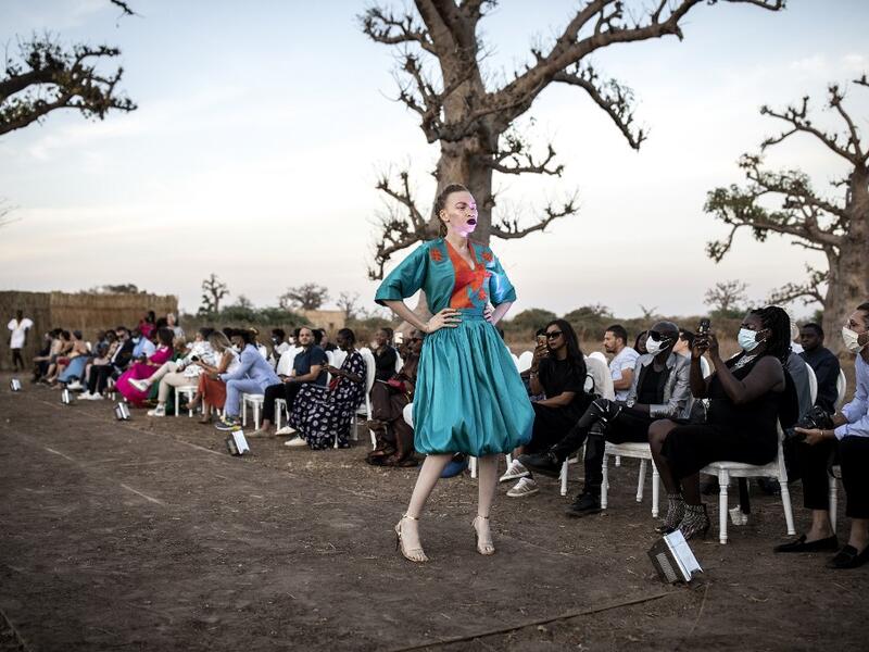 A fashion model poses at the end of the runway during Dakar Fashion Week in Dakar on December 12, 2020. JOHN WESSELS / AFP
