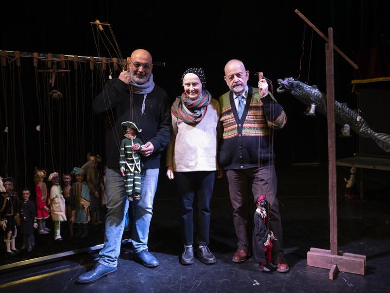 From left Marco, Maria Rosa and Augusto Grilli pose for a picture on November 30, 2020 at the " Alfa Theatre" in Turin. The Grilli family has a collection of more than 20,000 objects from around the world, everything from theatres, marionettes and glove puppets to shadow figures and silhouettes. A long-time dream of Grilli and his wife Mariarosa, 78, the museum is due to open in 2023 in Turin, financed both privately and publicly with the help of different institutions.  Marco Bertorello / AFP