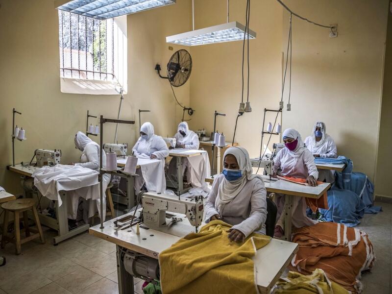 This picture taken during a government-guided tour on December 27, 2020 shows inmates operating sewing machines at a workshop at al-Qanatir women's prison, at the tip of the Nile delta in Qalyoubiya province, about 30 kilometres north of Egypt's capital. Khaled DESOUKI / AFP
