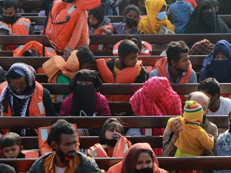 Rohingya refugees sit on a Bangladesh Navy ship as they are relocated to the controversial flood-prone island Bhashan Char in the Bay of Bengal, in Chittagong on December 29, 2020. Rehman ASAD / AFP