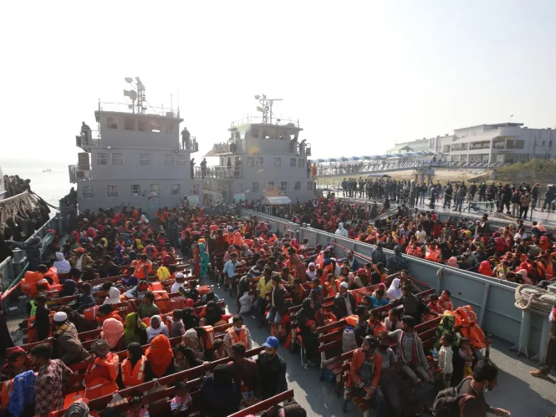 Rohingya refugees sit on a Bangladesh Navy ship as they are relocated to the controversial flood-prone island Bhashan Char in the Bay of Bengal, in Chittagong on December 29, 2020. Rehman ASAD / AFP