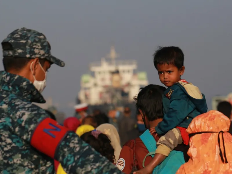 Rohingya refugees embark on a Bangladesh Navy ship as they are relocated to the controversial flood-prone island Bhashan Char in the Bay of Bengal, in Chittagong on December 29, 2020. Rehman ASAD / AFP
