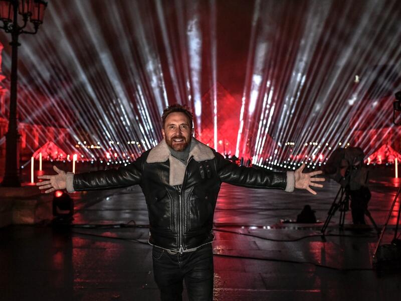 French DJ David Guetta poses on the stage set up for his 2021 New Year's eve livestream charity concert "United at Home", in the Cour Napoleon, in front of the Louvre Pyramid, in Paris, on December 29, 2020, amid the Covid-19 (novel coronavirus) pandemic. STEPHANE DE SAKUTIN / AFP