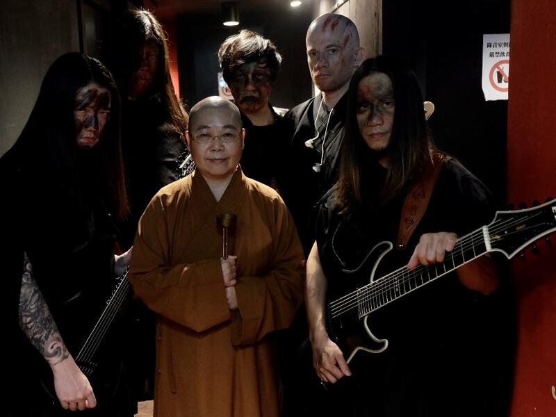 This picture taken on December 3, 2020 shows members of Taiwanese death metal band 'Dharma' posing for photographs during a rehearsal in Taipei. Sam Yeh / AFP