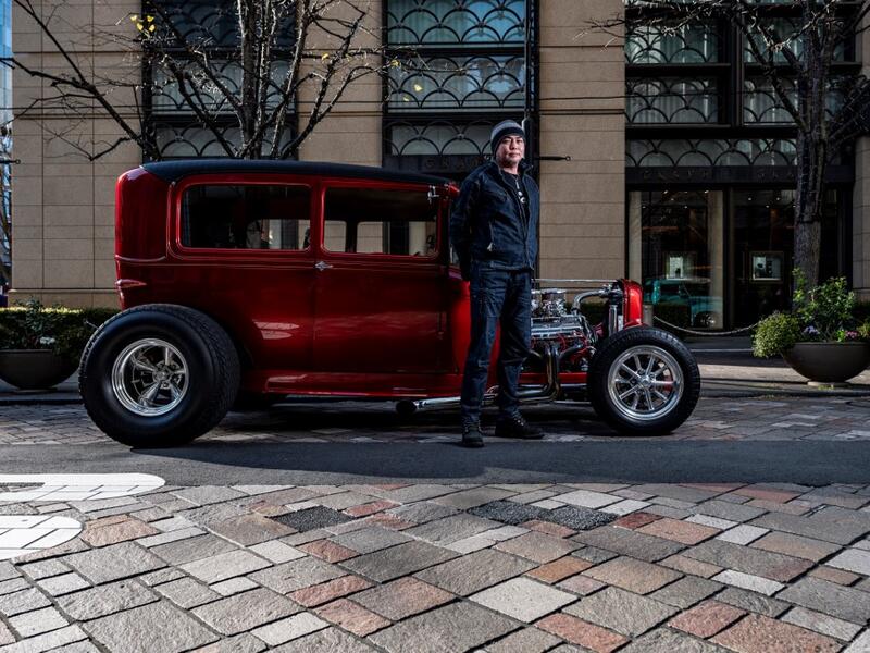 This picture taken on January 16, 2021 shows Kazutaka Fukuda, who works in the construction industry, posing for a photo in front of a 1929 Ford Model A during a gathering of auto enthusiasts in Tokyo. A loose club of fans rolls up most weekends in central Tokyo to show off their Cadillacs, Chevrolets and other modern classic vehicles from the mid to late 20th century. Philip FONG / AFP