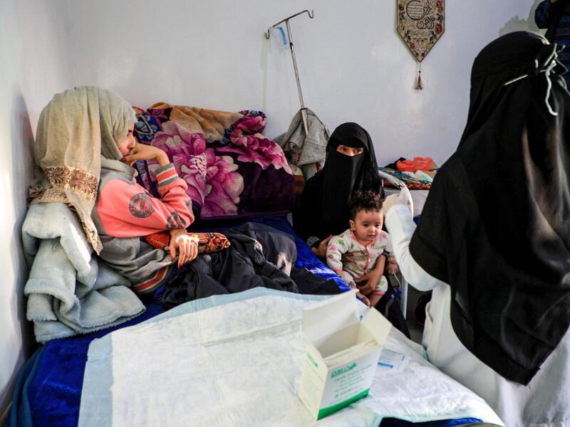 Al-Anoud Hussain Sheryan (L), a 19-year-old girl disfigured in an acid attack by her abusive husband, sits at a hospital where she is undergoing treatment in Yemen's capital Sanaa on January 28, 2021. Married at the age of 12, rejected at 16, and then disfigured in an acid attack, Sheryan's fate is a shocking illustration of abuse in a society beset by war and poverty. Now aged 19, the young Yemeni woman agreed to relate her ordeal at the hands of her abusive husband -- rare testimony in a country where dom