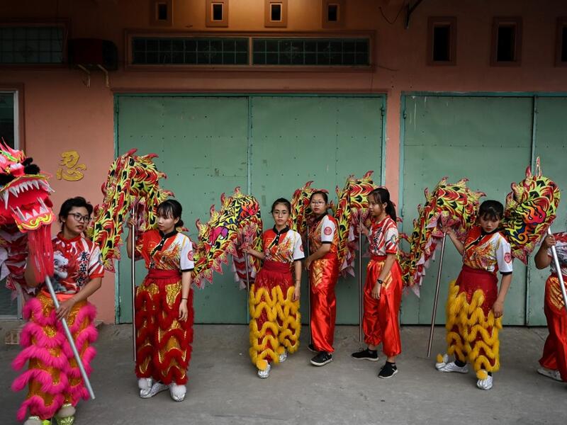 This photograph taken on January 20, 2021 shows Le Yen Quyen (L) practising a dragon dance routine along with other female dancers at the Tu Anh Duong lion and dragon dance school in Can Tho city in southern Vietnam's Mekong Delta. Manan VATSYAYANA / AFP