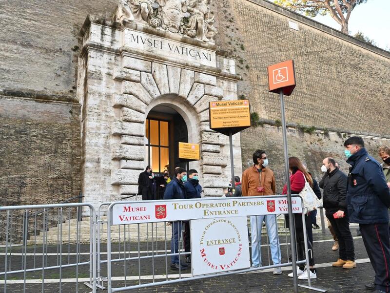 People wait at the entrance to the Vatican Museum, which reopens to the public on February 1, 2021 in Vatican City, as the city-state eases its closure aimed at curbing the spread of the COVID-19 infection, caused by the new coronavirus. Andreas SOLARO / AFP