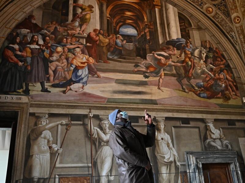 People visit one of Raphael's Rooms in the Vatican Museum, on its reopening day to the public on February 1, 2021 in Vatican City, as the city-state eases its closure aimed at curbing the spread of the COVID-19 infection, caused by the new coronavirus. Andreas SOLARO / AFP