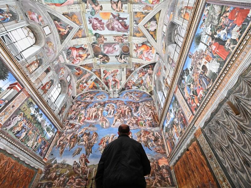 A man visits the Sistine Chapel on the reopening day of the Vatican museum on February 1, 2021 in Vatican City, as the city-state eases its closure aimed at curbing the spread of the COVID-19 infection, caused by the new coronavirus. Andreas SOLARO / AFP