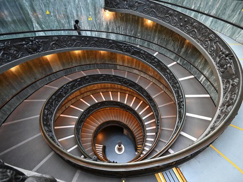 A man walks down the Bramante Staircase as he visits the Vatican museum on its reopening day, on February 1, 2021 in Vatican City, as the city-state eases its closure aimed at curbing the spread of the COVID-19 infection, caused by the new coronavirus. Andreas SOLARO / AFP