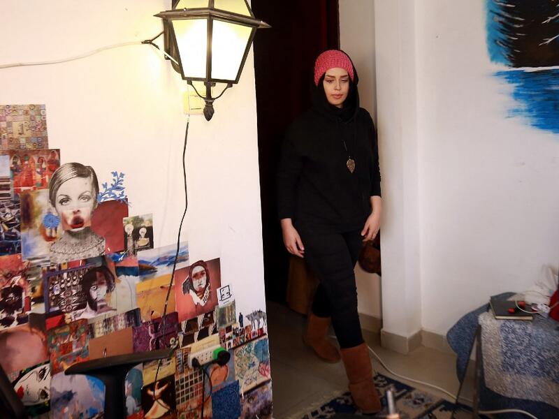 Jordanian make-up artist Alaa Bliha, 27, enters her room in the basement apartment where she lives with her mother and young brother in the capital Amman, on February 2, 2021. Bliha has beaten the lockdown blues and shot to online fame with videos of herself imitating famous figures from across the Arab world and beyond. From Donald Trump and Queen Elizabeth II to Egyptian superstars like singer Umm Kalthum and actor Adel Imam, her characters have made Alaa Bliha a star in her own right, with tens of thousa