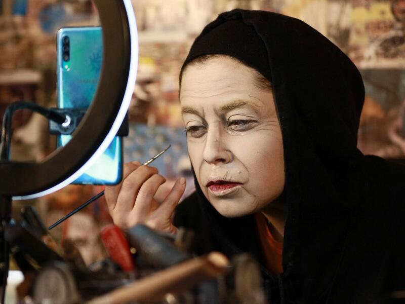Jordanian make-up artist Alaa Bliha, 27, works on her imitation make-up to resemble Queen Elizabeth II, in the basement apartment where she lives with her mother and young brother in the capital Amman, on February 2, 2021. Bliha has beaten the lockdown blues and shot to online fame with videos of herself imitating famous figures from across the Arab world and beyond. From Donald Trump and Queen Elizabeth II to Egyptian superstars like singer Umm Kalthum and actor Adel Imam, her characters have made Alaa Bli