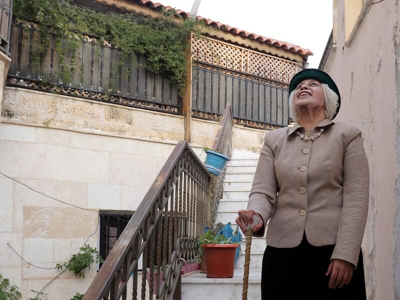 Jordanian make-up artist Alaa Bliha, 27, poses for a picture after completing her make-up to resemble Queen Elizabeth II, near the basement apartment where she lives with her mother and young brother in the capital Amman, on February 2, 2021. Bliha has beaten the lockdown blues and shot to online fame with videos of herself imitating famous figures from across the Arab world and beyond. From Donald Trump and Queen Elizabeth II to Egyptian superstars like singer Umm Kalthum and actor Adel Imam, her character