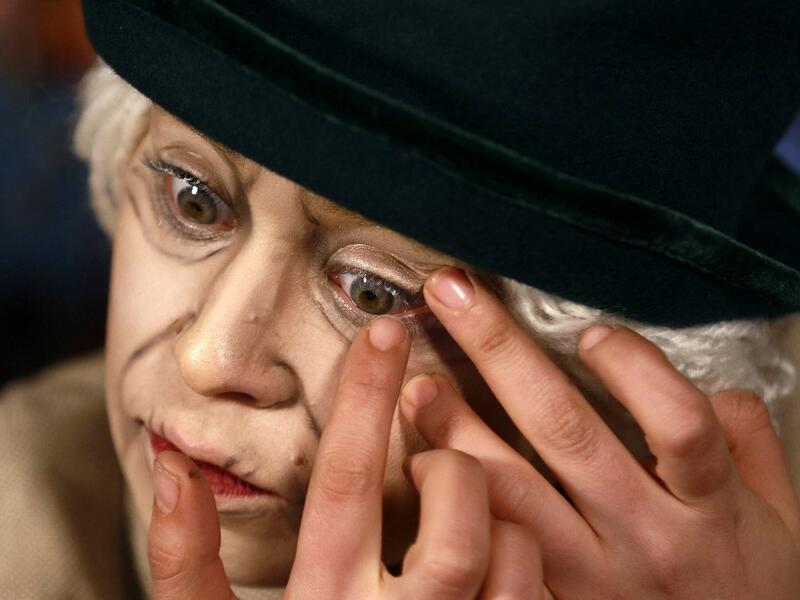 Jordanian make-up artist Alaa Bliha, 27, applies coloured eye lenses to complete her imitation make-up to resemble Queen Elizabeth II, in the basement apartment where she lives with her mother and young brother in the capital Amman, on February 2, 2021. Bliha has beaten the lockdown blues and shot to online fame with videos of herself imitating famous figures from across the Arab world and beyond. From Donald Trump and Queen Elizabeth II to Egyptian superstars like singer Umm Kalthum and actor Adel Imam, he