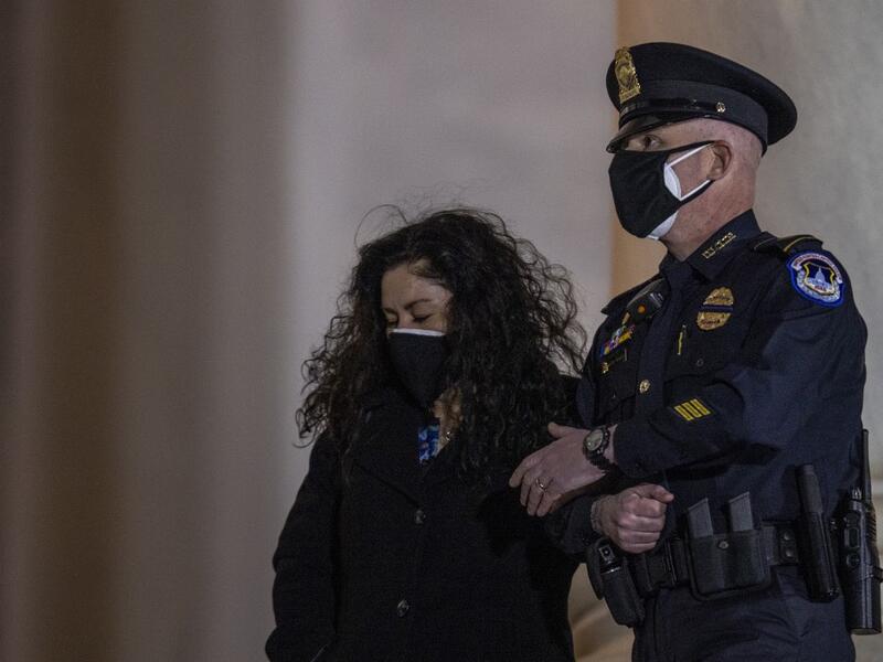 The family of late US Capitol Police officer Brian Sicknick, watch as his remains are carried up the steps of the Capitol in Washington, DC February 2, 2021. US President Joe Biden paid his respects Tuesday at a solemn memorial to the policeman killed last month during an attack on the Capitol by Donald Trump's supporters.  Tasos Katopodis / POOL / AFP