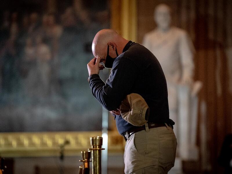 Capitol Police Officers pay their respects to late US Capitol Police officer Brian Sicknick as he lies in honor in the US Capitol Rotunda in Washington, DC February 2, 2021. Erin Schaff / POOL / AFP