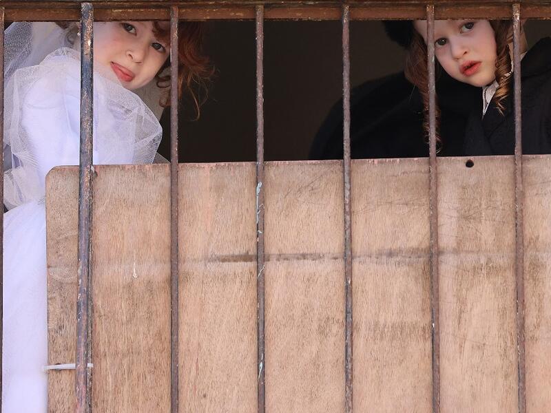 Israeli children dressed in costumes in celebration of the Jewish holiday of Purim are pictured in the ultra-Orthodox neighborhood of Bnei Brak, on February 26, 2021. Israel imposed a night-time curfew for three nights from yesterday evening to curb the spread of the coronavirus during the Jewish holiday of Purim, the government said. The curfew, from 8:30 pm to 5:00 am daily (1830 GMT to 0300 GMT), will be in force from Thursday night until Sunday morning, a joint statement from the prime minister's office