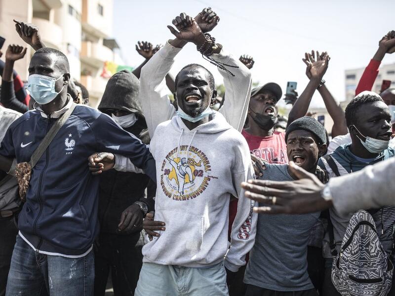 Supporters of main opposition candidate, Ousmane Sonko, gather in protest outside the Justice Palace calling for his release in Dakar on March 8, 2021. Protests have been ongoing after the Senegal opposition leader Ousmane Sonko was arrested following rape charges. JOHN WESSELS / AFP