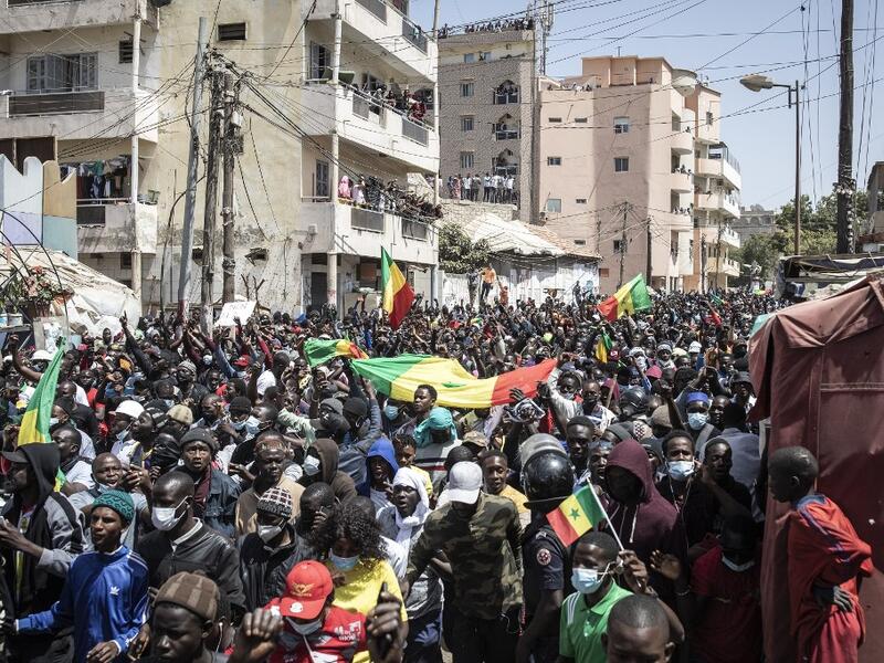 Supporters of main opposition candidate, Ousmane Sonko, react after Sonko was released from detention in Dakar on March 8, 2021. A Senegalese judge charged opposition leader Ousmane Sonko with rape and freed him from detention pending an investigation on March 8, 2021, after his arrest last week sparked the West African state's worst unrest in years. JOHN WESSELS / AFP