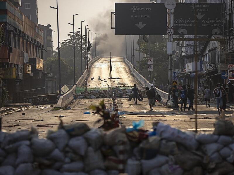 Protesters carry tires to construct makeshift barricades 