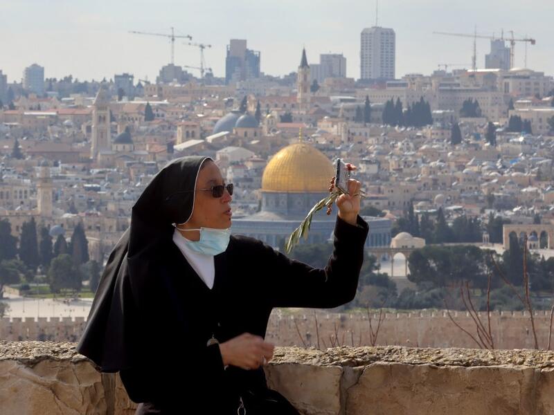 A nun takes a selfie during a Palm Sunday 